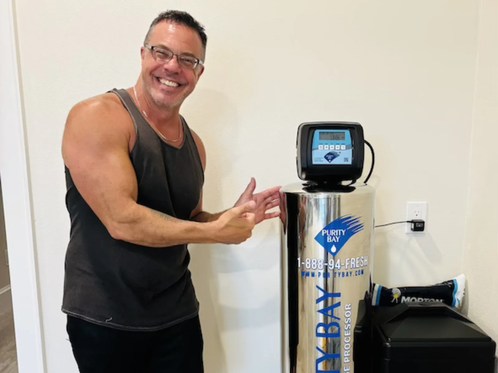 Tampa homeowner beside his new Purity Bay whole home water system
